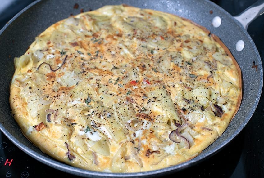 Spanish Tortilla Omelette with Chilli, Thyme, and Garlic in large frying pan
