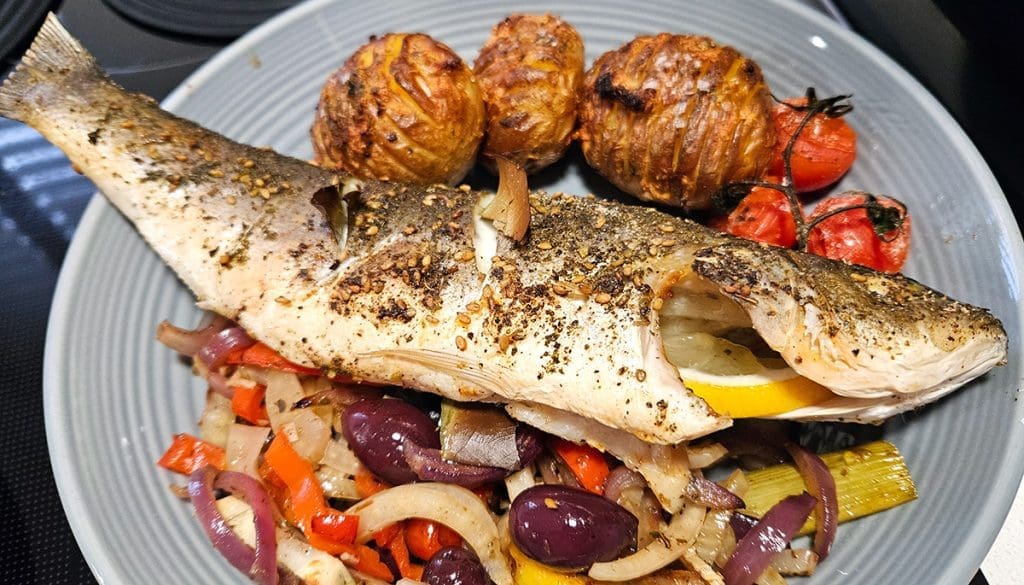 Baked Whole Sea Bass with Mediterranean Vegetables served with a side of air fried roast potatoes