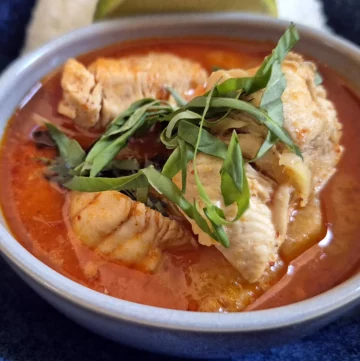 Thai Red Curry with Chicken and Pineapple, served with steamed jasmine rice and a wedge of lime.
