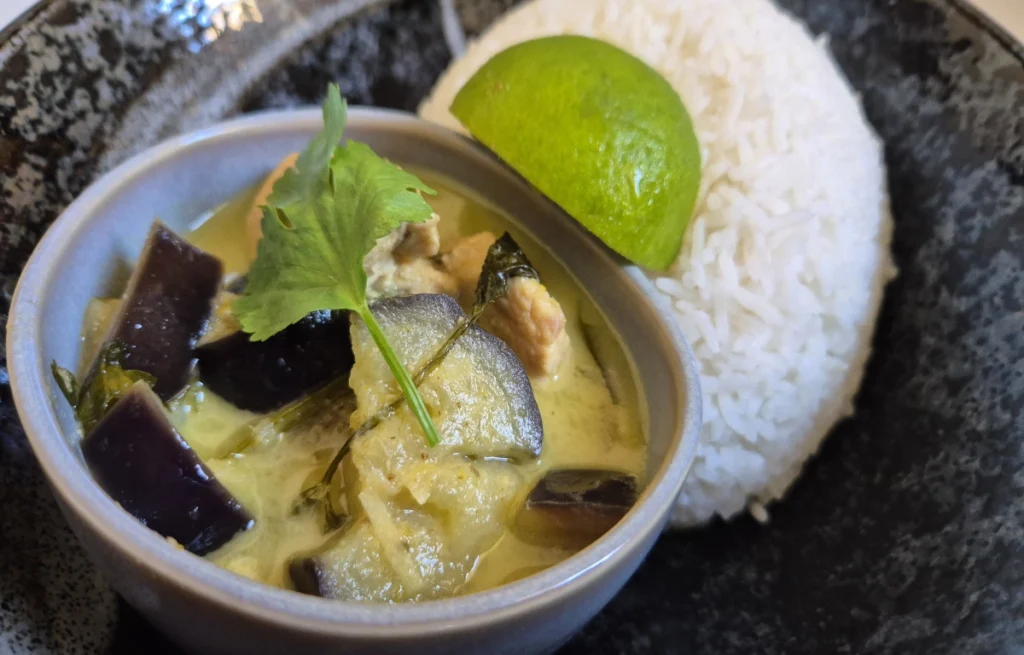 Thai Green Curry with Chicken and Aubergine served with jasmine rice and a wedge of lime